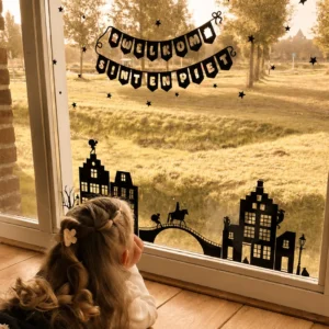 Raamstickers voor sinterklaas geplakt op het raam een meisje kijkt erna